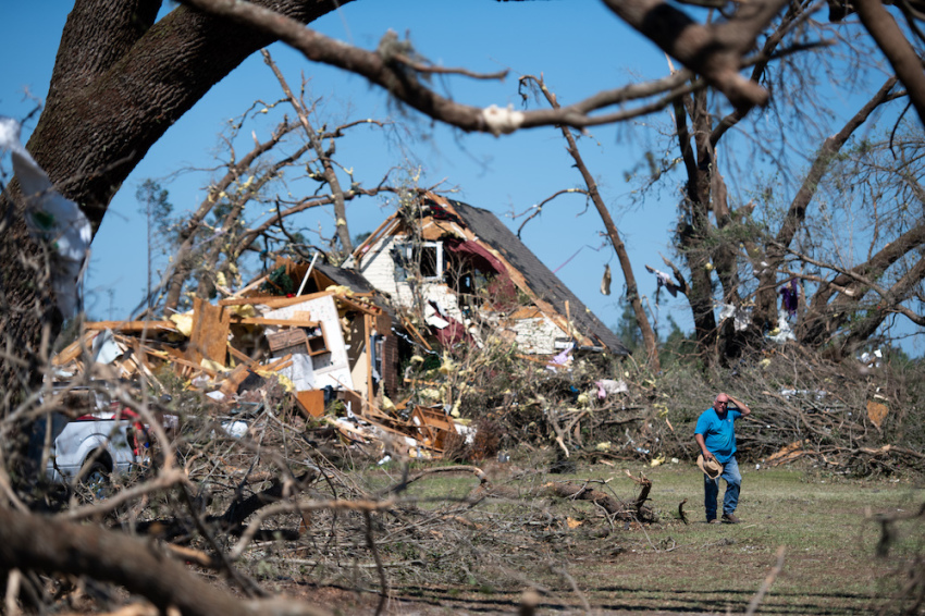 A man walks in front of a home destroyed by a tornado on April 13, 2020, near Nixville, South Carolina. A string of storms across the southern United States that began Easter Sunday and continued into Monday produced multiple tornados resulting in more than 30 deaths and dozens more injuries.