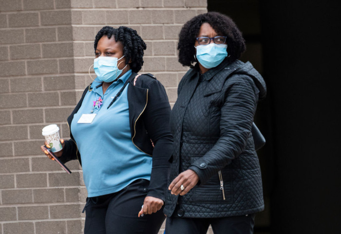 Medical workers wear masks as they walk back to the George Washington University hospital in Washington, D.C. on March 31, 2020.