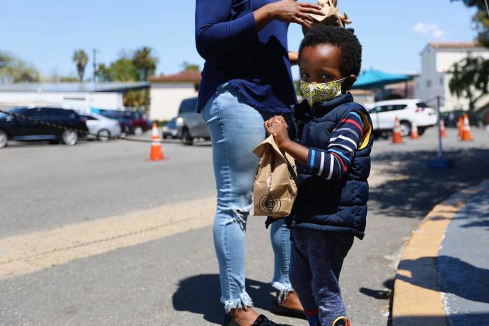 A child receives food at the Dream Center in Los Angeles, April 2020.