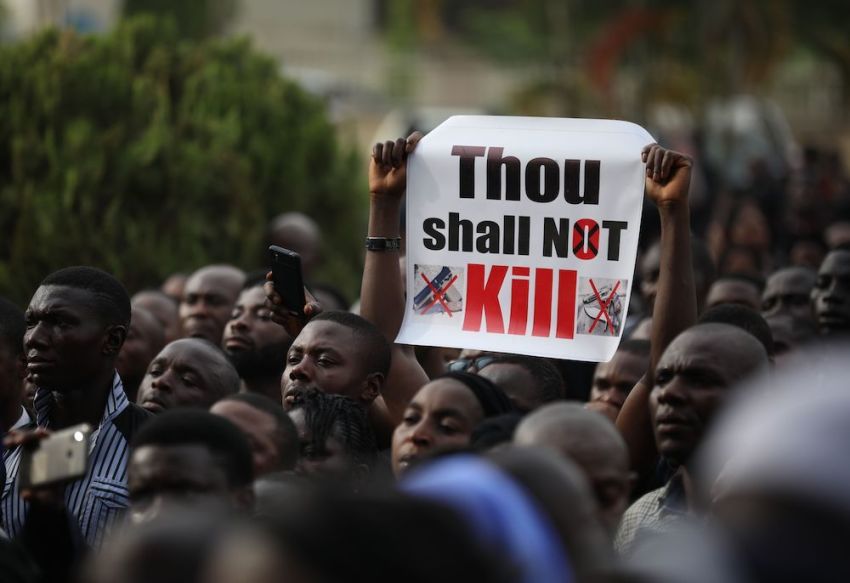 Christians hold signs as they march on the streets of Abuja during a prayer and penance for peace and security in Nigeria in Abuja on March 1, 2020. The Catholic Bishops of Nigeria gathered faithful and other Christians and other people to pray for security and to denounce the barbaric killings of Christians by the Boko Haram insurgents and the incessant cases of kidnapping for ransom in Nigeria. 