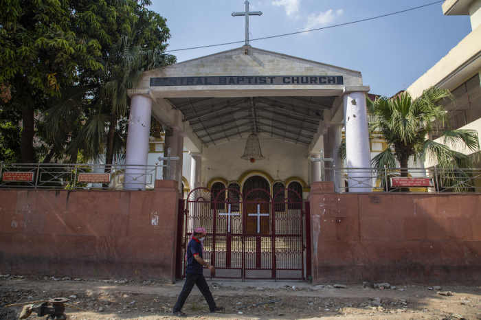 An Indian man walks outside a deserted church, as India remains under an unprecedented extended lockdown over the highly contagious coronavirus (COVID-19) on May 5, 2020, in Delhi, India. 