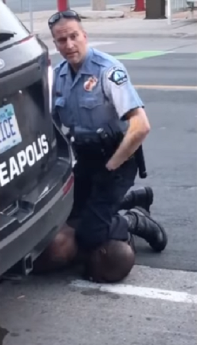 A Minneapolis officer with his knee on the neck of George Floyd