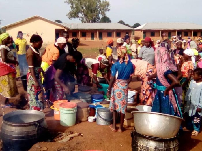 Internally displaced people in the Rimau village of Kajuru local government area in the Kaduna state of Nigeria cook food that was donated to them on May 25, 2020. 