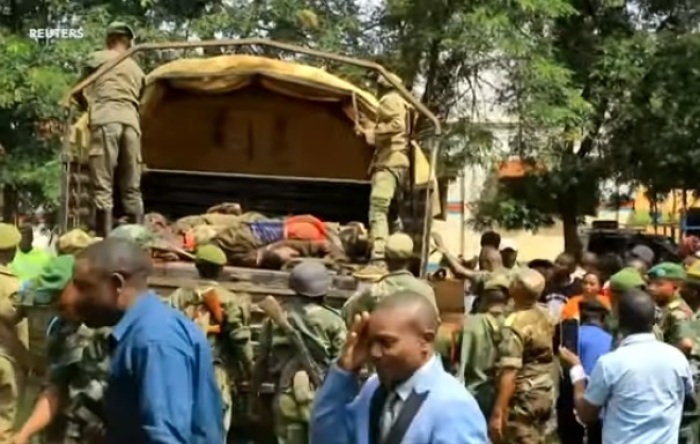 Congolese security forces load dead bodies of rebel militants onto a truck after repelling an attack on a village near the city of Beni in May 2019. 