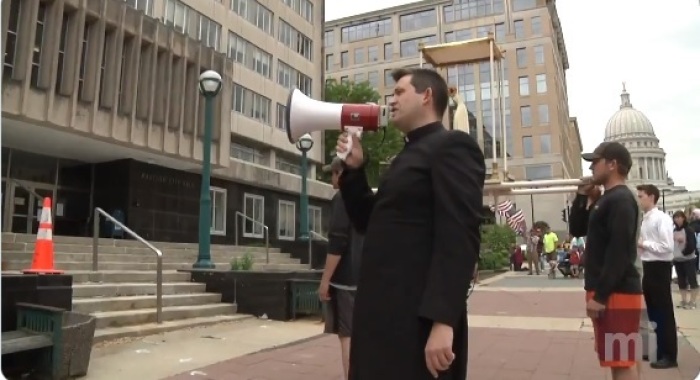 Priest Brian Dulli of St. Patrick Catholic Church in Cottage Grove speaks during a demonstration outside the City-County Building in Madison, Wisconsin on May 29, 2020.