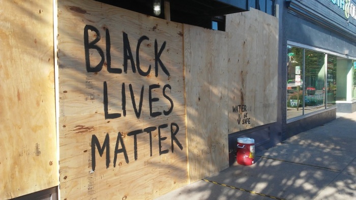 A store in Richmond, Virginia boarded up and spray-painted in preparation for protests against police brutality and racism. The owners left water for demonstrators to take. Other nearby stores had bottled water instead. Photo taken June 1, 2020. 