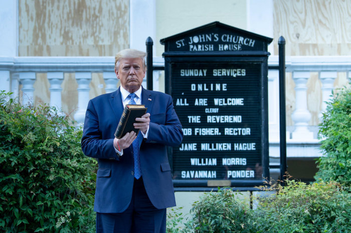 US President Donald Trump holds a Bible while visiting St. John's Church across from the White House after the area was cleared of people protesting the death of George Floyd June 1, 2020, in Washington, DC. 