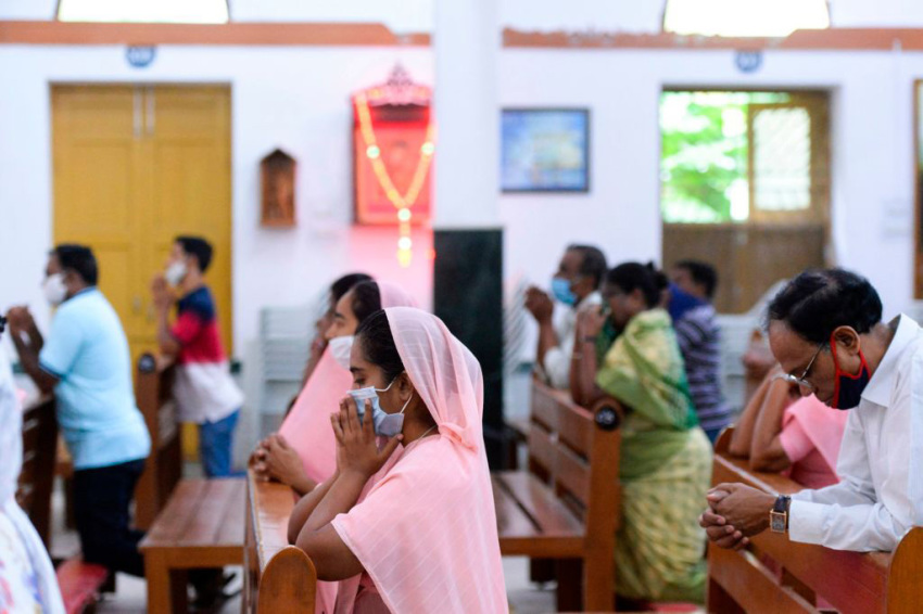 Catholic devotees wear face mask attend the Holy Mass at the Saint Joseph's Church on the first day after the reopening of religious services after the government eased restrictions imposed as a preventive measure against the COVID-19 coronavirus, in Hyderabad on June 8, 2020.