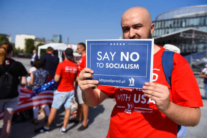 A Trump supporter holds a sign saying 'Say No To Socialism' during an international ceremony attended by leaders from NATO member states as well as other countries across Europe to commemorate the 80th anniversary of the outbreak of World War II on September 1, 2019, in Warsaw, Poland. 