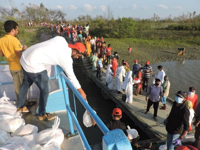 Aid workers with the Believers Eastern Church distribute relief items to residents of Kankandighi island in West Bengal impacted by Cyclone Amphan in June 2020.