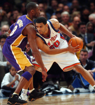 New York Knicks' Allan Houston (R) leans into Los Angeles Lakers Kobe Bryant (L) in the first quarter at Madison Square Garden in New York, February 6, 2003. 