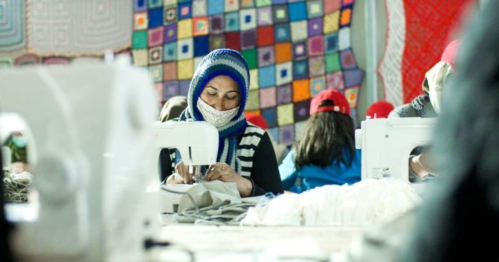 A refugee at Moria Camp in Lesbos, Greece, sews a cotton face covering. Refugees at the camp have made thousands of cotton face masks during the coronavirus pandemic, some of which are being distributed at evangelical churches in the United States. 