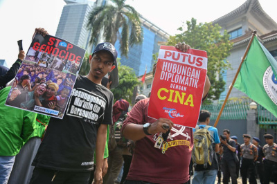 Indonesian protesters display posters during a rally to show support for the Uighur minority in China, outside the Chinese embassy in Jakarta on December 20, 2019. - China has faced growing international condemnation for rounding up an estimated one million Uighurs and other mostly Muslim ethnic minorities in a network of internment camps. Beijing initially denied the existence of the camps, but now says they are 'vocational training centres' necessary to combat terrorism. 