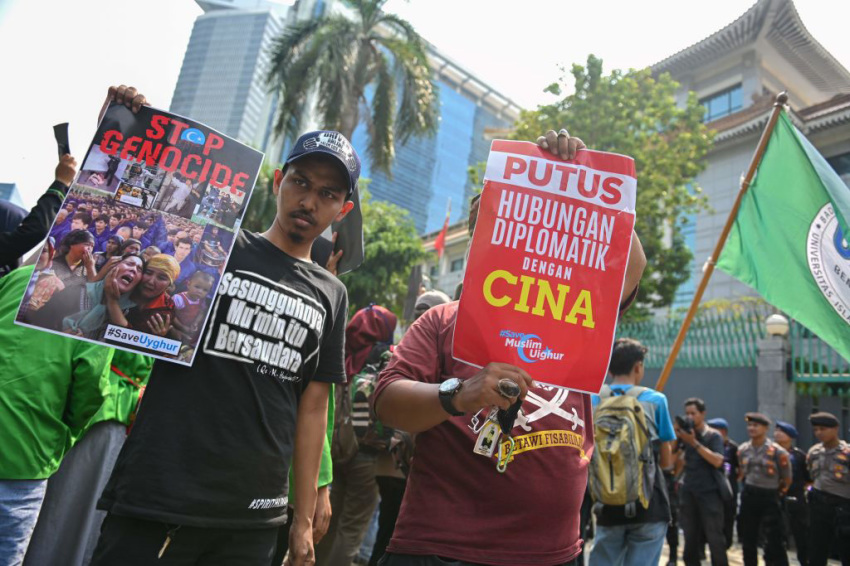 Indonesian protesters display posters during a rally to show support for the Uighur minority in China, outside the Chinese embassy in Jakarta on December 20, 2019. - China has faced growing international condemnation for rounding up an estimated one million Uighurs and other mostly Muslim ethnic minorities in a network of internment camps. Beijing initially denied the existence of the camps, but now says they are "vocational training centres" necessary to combat terrorism.