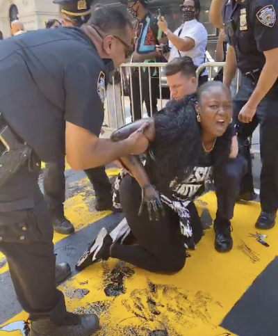 Bevelyn Beatty of At The Well Ministries is detained by police outside Trump Tower in New York City on July 18, 2020.