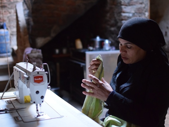 A woman from Egypt sewing as part of her business. Her business was possible due to microloans from The International Christian Concern's Hope House program.