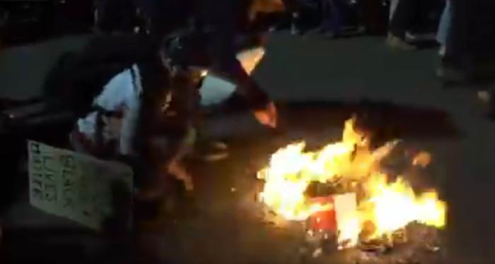 Bibles are shown being burned in Portland.