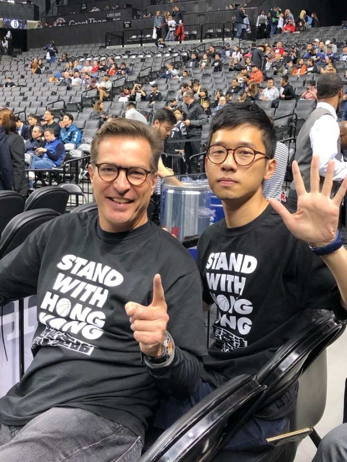 Nathan Law (right) at an NBA game where protesters showed up to support Hong Kong's rights. 