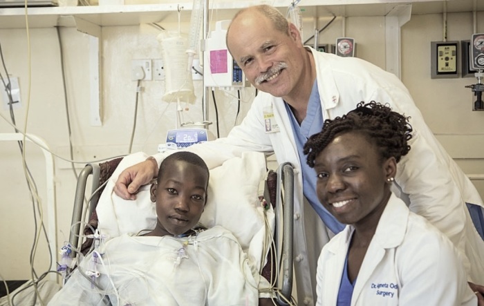 Dr. Russ White, a missionary doctor at the Tenwek Hospital in Monrovia, Liberia, poses for a photo with a patient and cardiothoracic surgeon, Dr. Agneta Odera, whom White trained. 