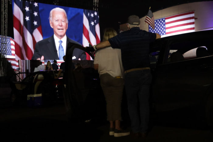 Supporters watch from a parking lot outside Chase Center Democratic presidential candidate former Vice President Joe Biden’s presidential nomination acceptance speech during the Democratic National Convention Aug. 20, 2020 in Wilmington, Delaware. 
