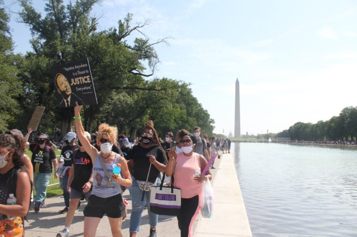 Demonstrators participate in the Get Your Knee Off Our Necks Commitment March in Washington D.C. on Aug. 28. 2020.