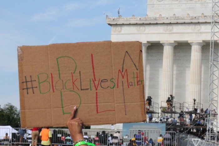 A demonstrator holds up a Black Lives Matter sign while participating in the Get Your Knee Off Our Necks Commitment March in Washington D.C. on Aug. 28. 2020.
