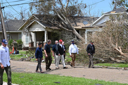 U.S. President Donald Trump (red cap) tours the damage caused by Hurricane Laura, in Lake Charles, Louisiana, on August 29, 2020. At least 15 people were killed after Laura slammed into the southern U.S. states of Louisiana and Texas, authorities and local media said on August 28.