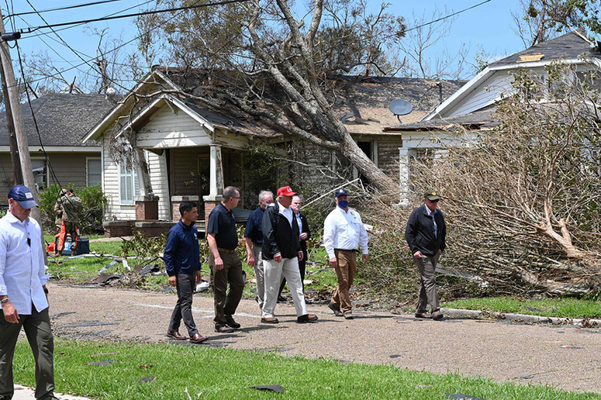 U.S. President Donald Trump (red cap) tours the damage caused by Hurricane Laura, in Lake Charles, Louisiana, on August 29, 2020. At least 15 people were killed after Laura slammed into the southern U.S. states of Louisiana and Texas, authorities and local media said on August 28.