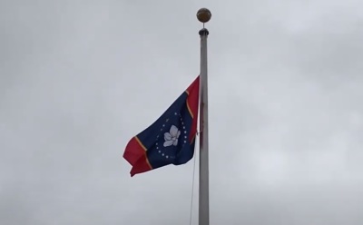 The proposed 'In God We Trust' flag flies outside the Old State Capitol Museum in downtown Jackson, Miss.
