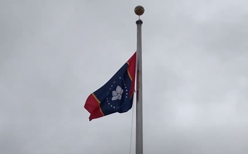 The proposed "In God We Trust" flag flies outside the Old State Capitol Museum in downtown Jackson, Miss.