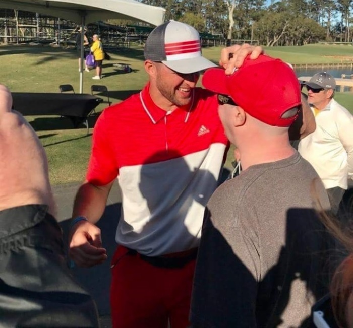 Tim Tebow speaks with Brandon Berry at the Tim Tebow Foundation golf tournament in Jacksonville, Florida in March 2018. 
