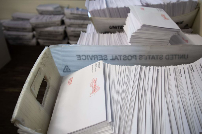 Large boxes of envelopes are seen as absentee ballot election workers stuff ballot applications at the Mecklenburg County Board of Elections office in Charlotte, North Carolina on September 4, 2020.
