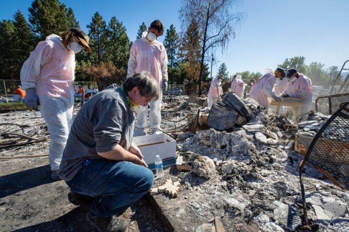 Samaritan's Purse volunteers help homeowner Stephen MacAulay sift through the ash of his burned-down home in Jackson County, Oregon, following a wildfire in September 2020. 