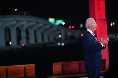 Democratic presidential nominee and former Vice President Joe Biden checks his watch during an NBC Town Hall event at the Perez Art Museum, with the MacArthur Causeway in the background, in Miami, Florida on October 5, 2020. 