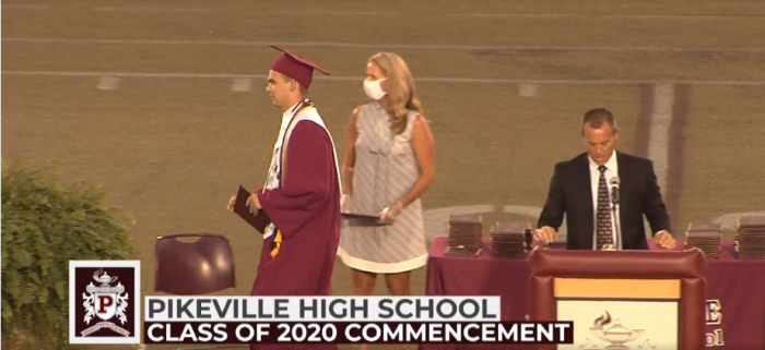 The salutatorian of Pikeville High School in Pikeville, Ky., accepts his diploma at the 2020 graduation ceremony. 