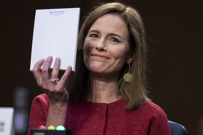 Supreme Court justice nominee Judge Amy Coney Barrett holds up her notepad at the request of Sen. John Cornyn, R-Texas, on the second day of her Senate Judiciary Committee confirmation hearing in Hart Senate Office Building on October 13, 2020, in Washington, D.C. Barrett was nominated by President Donald Trump to fill the vacancy left by Justice Ruth Bader Ginsburg who passed away in September. 