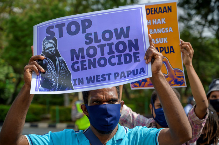 Papuan students show posters during a protest in front of the US embassy in Jakarta, on August 15, 2020, demanding that the United States take responsibility for the signing of the New York Agreement between the Netherlands and Indonesia which handed Papua over to Indonesia, on August 15, 1962. 