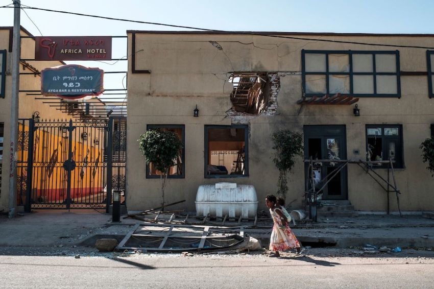 Children play in front of a hotel damaged by mortar shelling, in Humera, Ethiopia, on November 22, 2020. Prime Minister Abiy Ahmed, last year's Nobel Peace Prize winner, announced military operations in Tigray on November 4, 2020, saying they came in response to attacks on federal army camps by the party, the Tigray People's Liberation Front (TPLF). Hundreds have died in nearly three weeks of hostilities that analysts worry could draw in the broader Horn of Africa region, though Abiy has kept a lid on the details, cutting phone and internet connections in Tigray and restricting reporting.