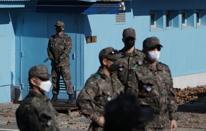 South Korean army soldiers stand guard during a reopening ceremony for border village of Panmunjom between South and North Korea in the demilitarized zone (DMZ) on November 04, 2020, in Panmunjom, South Korea. Unification Minister Lee In-young called Wednesday for North Korea to restore severed cross-border communications lines and resume the operation of a now-destructed joint liaison office to bring the stalled inter-Korean relations back on track 