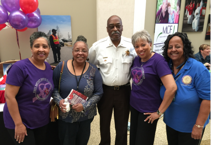 The Rev. Linda Thomas (2nd from right) stands next to Sheriff Melvin High, a partner in the fight against domestic violence, at First Baptist Church of Glenarden's annual Red Flag Conference designed to educate domestic violence survivors about the red flags of unhealthy relationships.