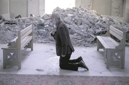 A man prays in Ghazanchetsots Cathedral in Shusha, Azerbaijan after it was partly destroyed by shelling in October 2020.