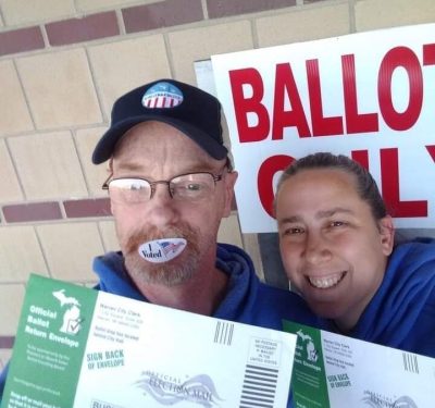 Ronald Hawthorne (L) and his wife vote early at a drop-off ballot box in Warren, Michigan ahead of the 2020 presidential election. 