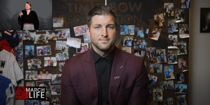 Former National Football League player Tim Tebow speaks at the virtual March for Life in Washington, D.C., with a sign language interpreter present in a separate live feed, on Friday, Jan. 29, 2021. 