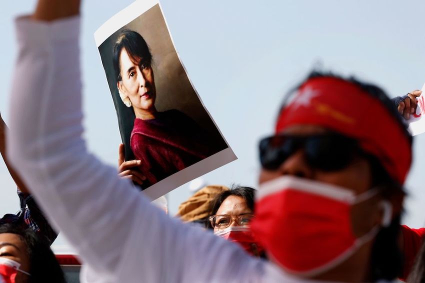 A group of Myanmar activists residing in Israel hold up a portrait of ousted leader Aung San Suu Kyi as they chant slogans during a protest outside the country's embassy in the Mediterranean coastal city of Tel Aviv on February 3, 2021. 