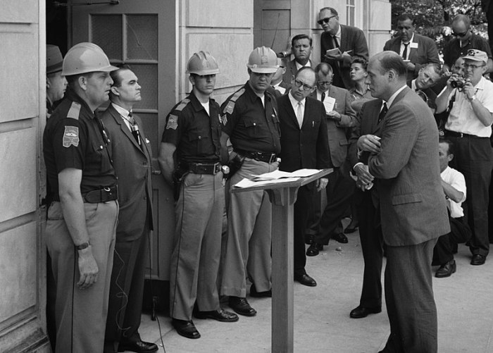 Attempting to block integration at the University of Alabama, Gov. George Wallace stands defiantly at the door while being confronted by Deputy U.S. Attorney General Nicholas Katzenbach. 