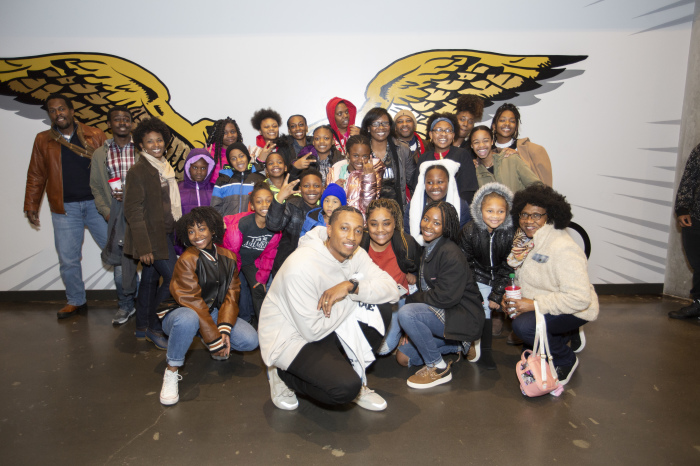 Lecrae with students and families from Peace Preparatory Academy at an Atlanta Hawks game. 