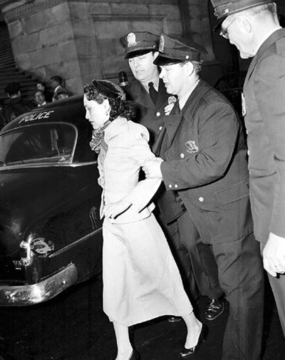 Lolita Lebrón (1919-2010), a Puerto Rican nationalist who led an armed assault in the U.S. Capitol in Washington, D.C., in 1954, being led away by police. Photo originally taken by an Associated Press photographer. 