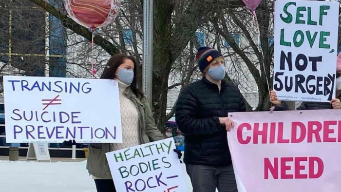 Parents protest outside gender clinics on Feb. 14, 2021. 
