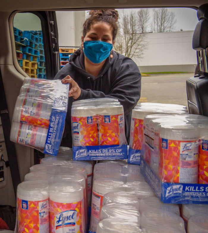 Rebecca Berry, the partnership coordinator and engagement specialist at Lakeridge Elementary School in Seattle, Washington, picks up cleaning supplies as teachers and students prepare to return to in-person learning.