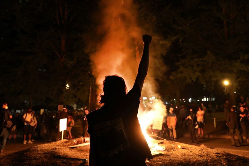 People gather to protest in front of the Mark O. Hatfield federal courthouse in downtown Portland, Oregon as the city experiences another night of unrest on July 27, 2020. For over 57 straight nights, protesters in downtown Portland have faced off in often violent clashes with the Portland Police Bureau and, more recently, federal officers.